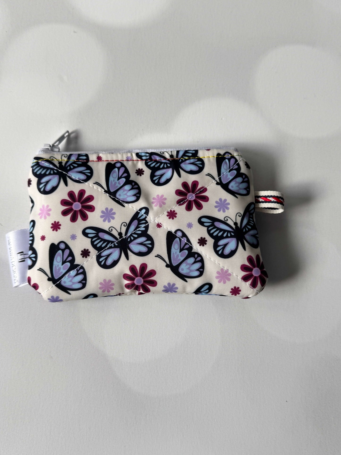 Butterfly coin wallet with colorful butterfly and flower pattern, perfect for storing coins and small items.