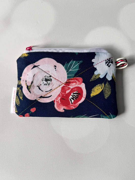 Rose coin wallet featuring a floral design with pink and white flowers on a navy background.