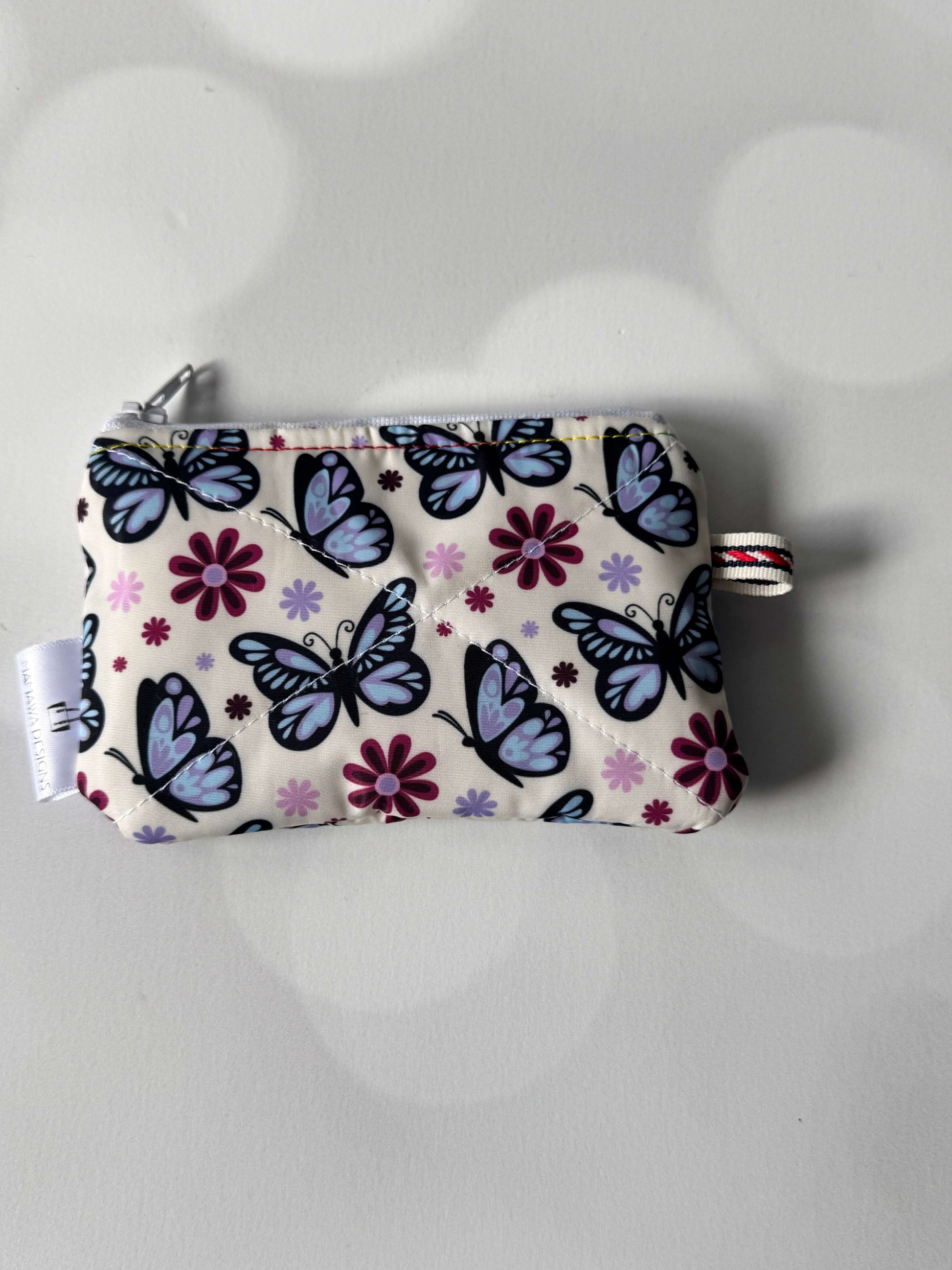 Butterfly coin wallet with colorful butterfly and flower pattern, perfect for storing coins and small items.